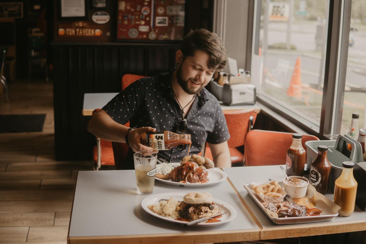 Man Eating BBQ at 3 Legged Pig