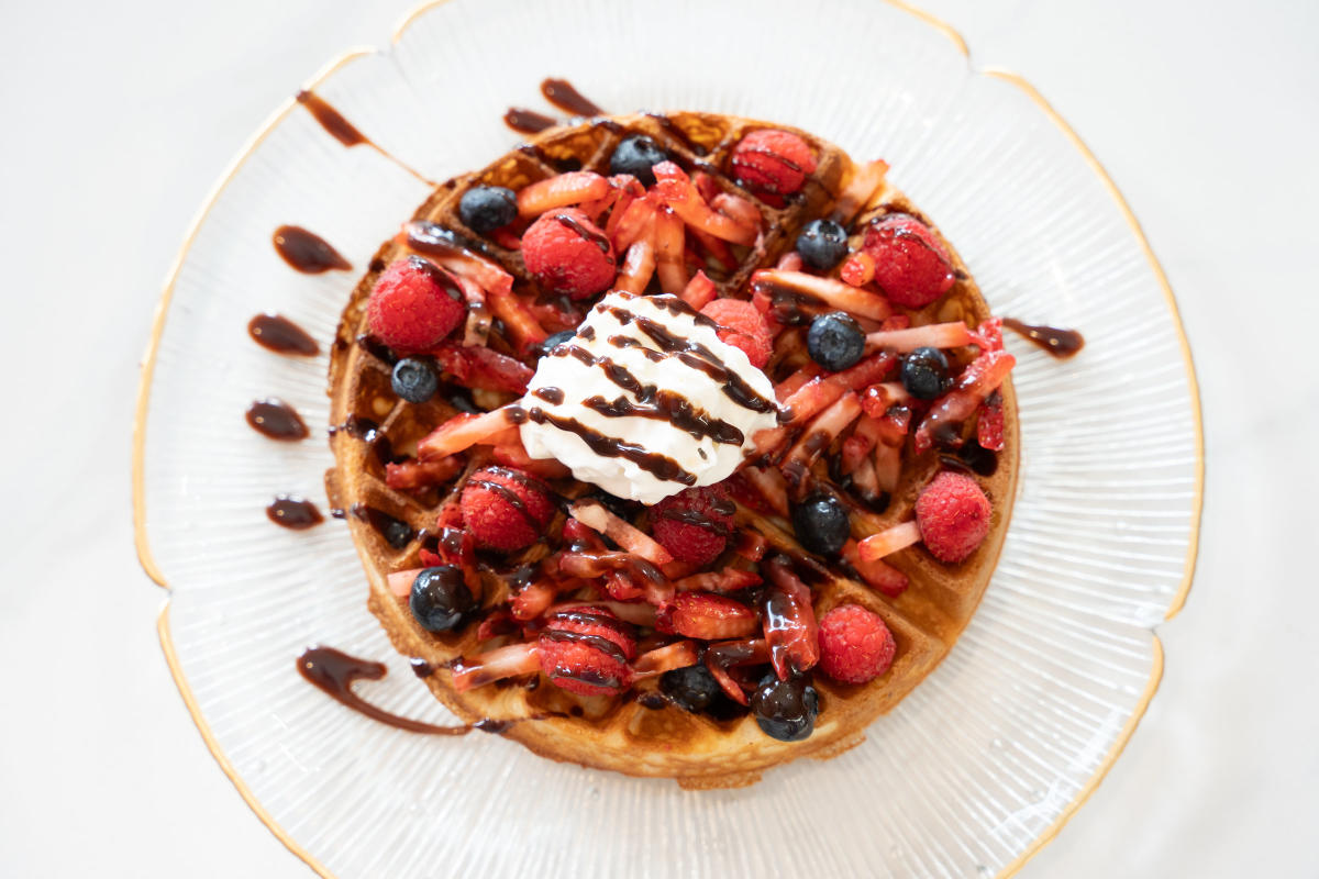 Waffle with berries and syrup