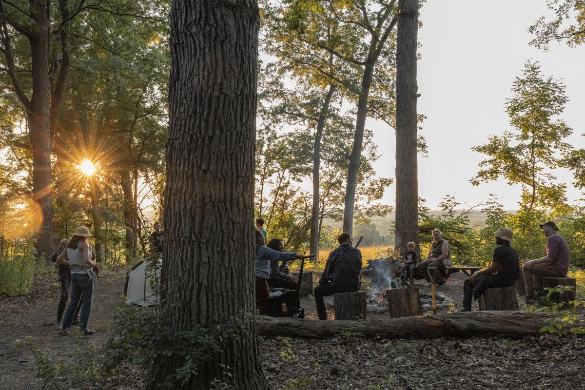 People sitting around campfire