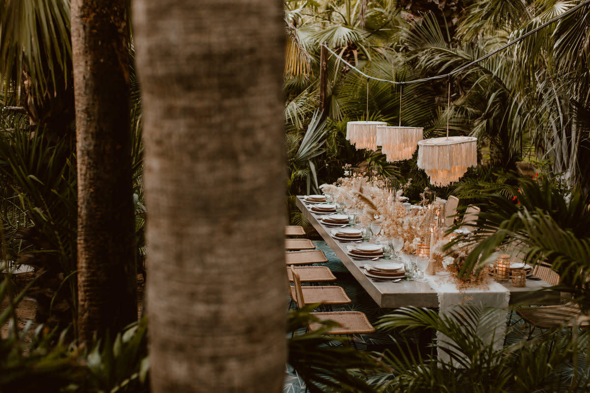 Dining table set near palm trees