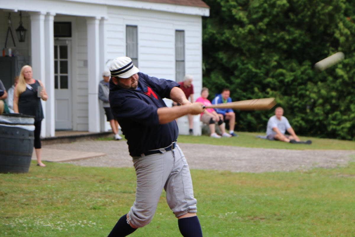 A batter hits the ball in a vintage base ball game at Mackinac Island’s Fort Mackinac