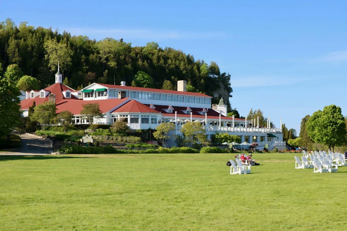 Adirondack chairs dot the massive green lawn at Mackinac Island’s Mission Point Resort