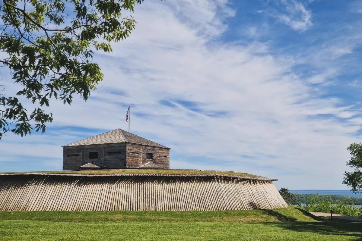 Fort Holmes sits atop the highest point of Mackinac Island with water in the distance below