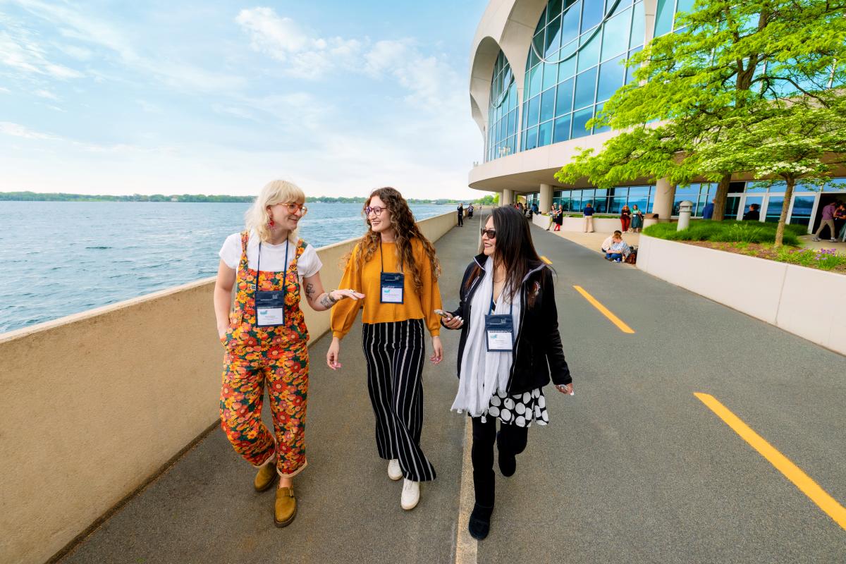 Three meeting attendees walking along the path near Monona Terrace