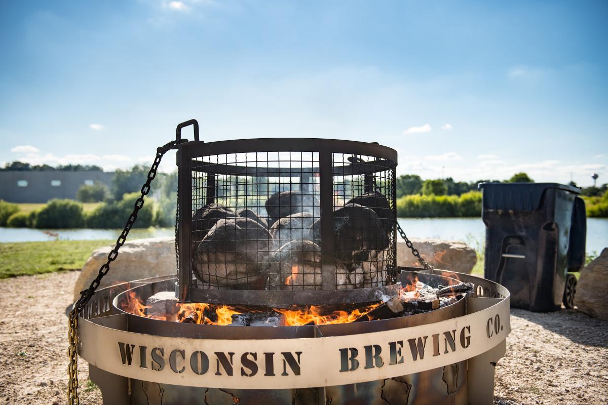 An outdoor fire pit by the lake at Wisconsin Brewing Company