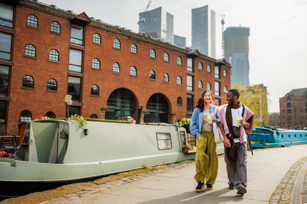 Image of a couple walking along the canal.