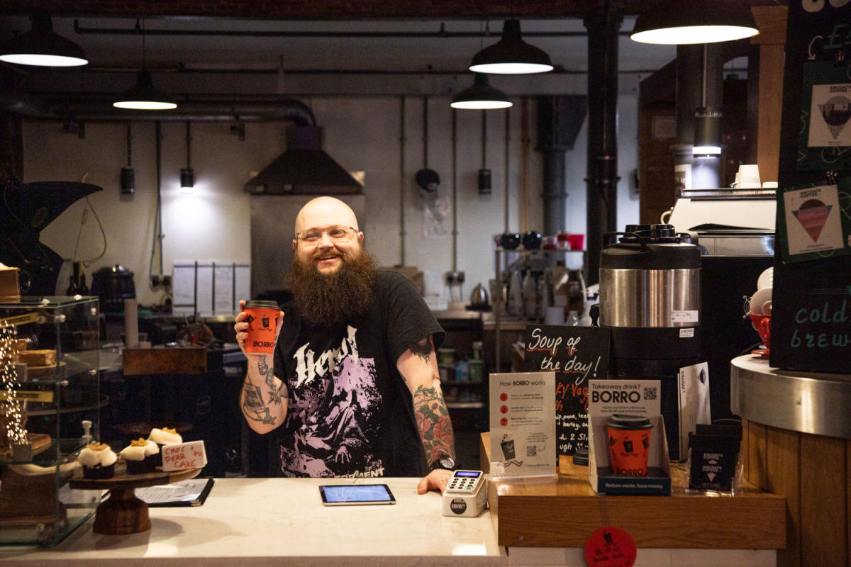Image of a guy holding up a Borro cup