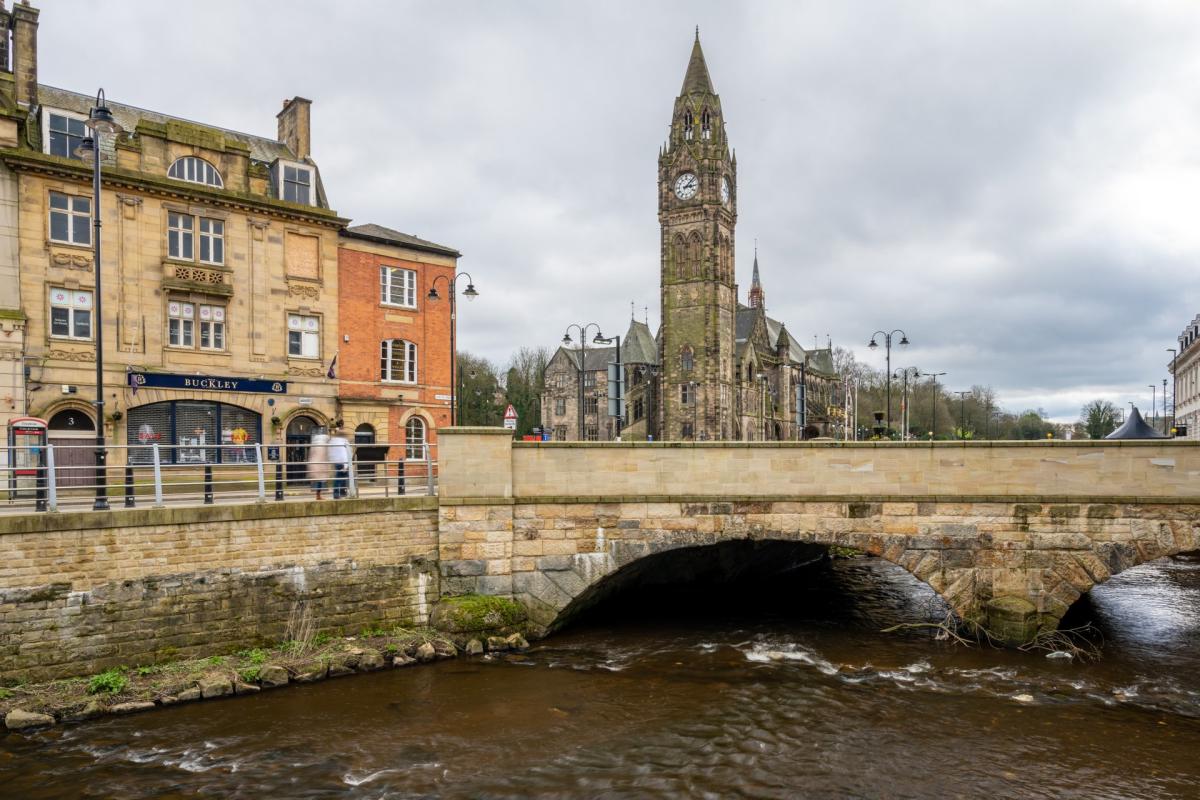 Canal under bridge with Rochdale Town Hall in the background