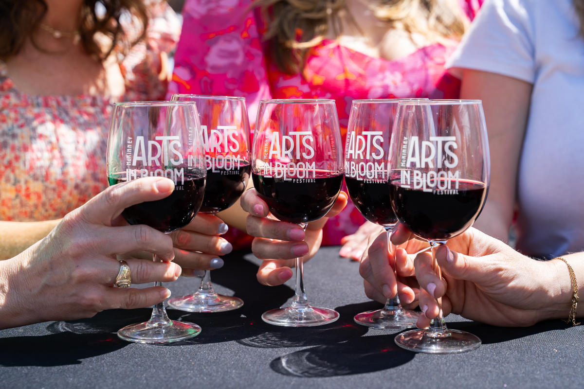 Close up photo of wine glasses at Arts In Bloom Wine Garden