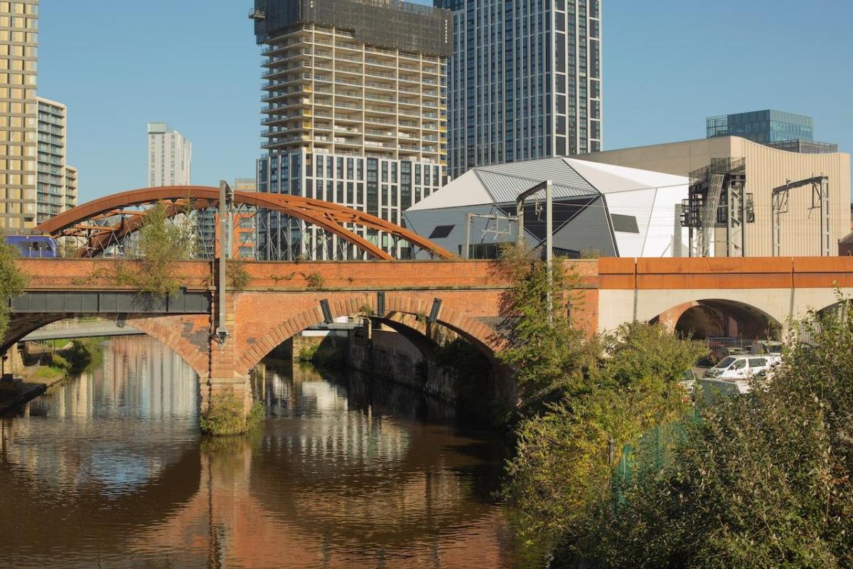River and bridge in a city with Aviva Studios in the background