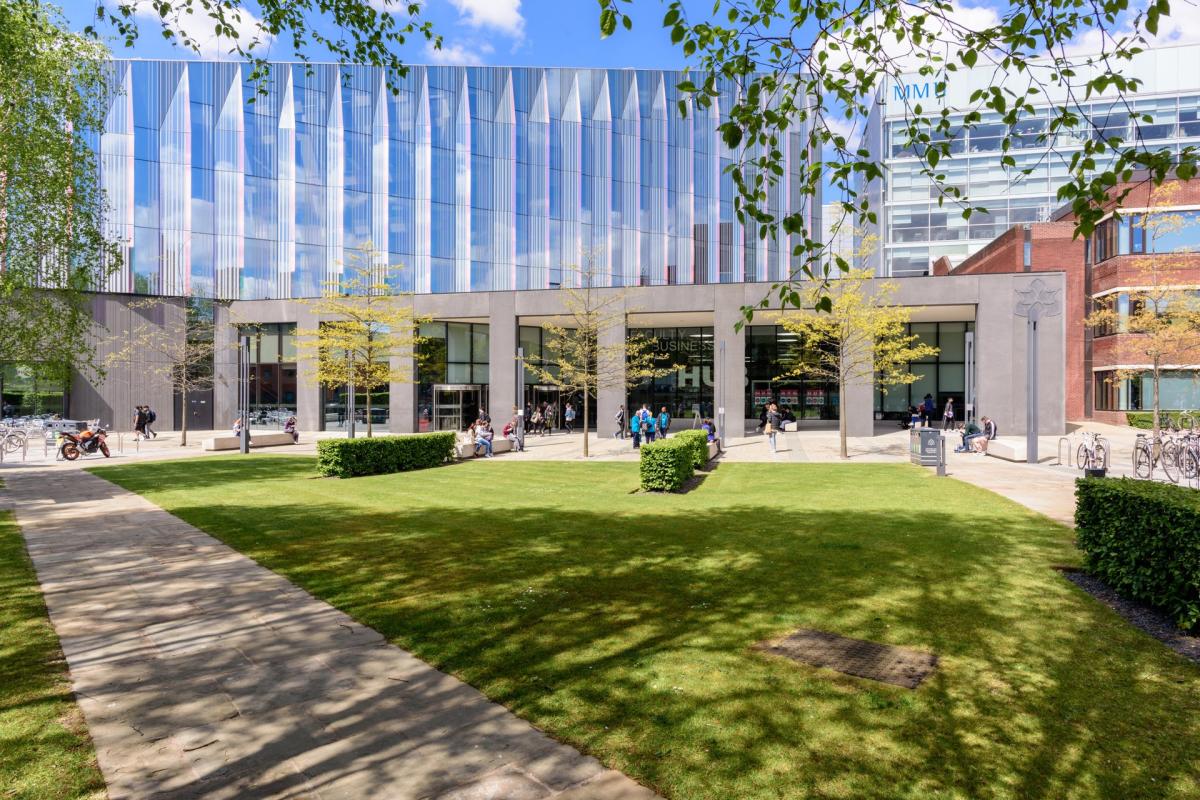 Building in the sun with green space in the foreground
