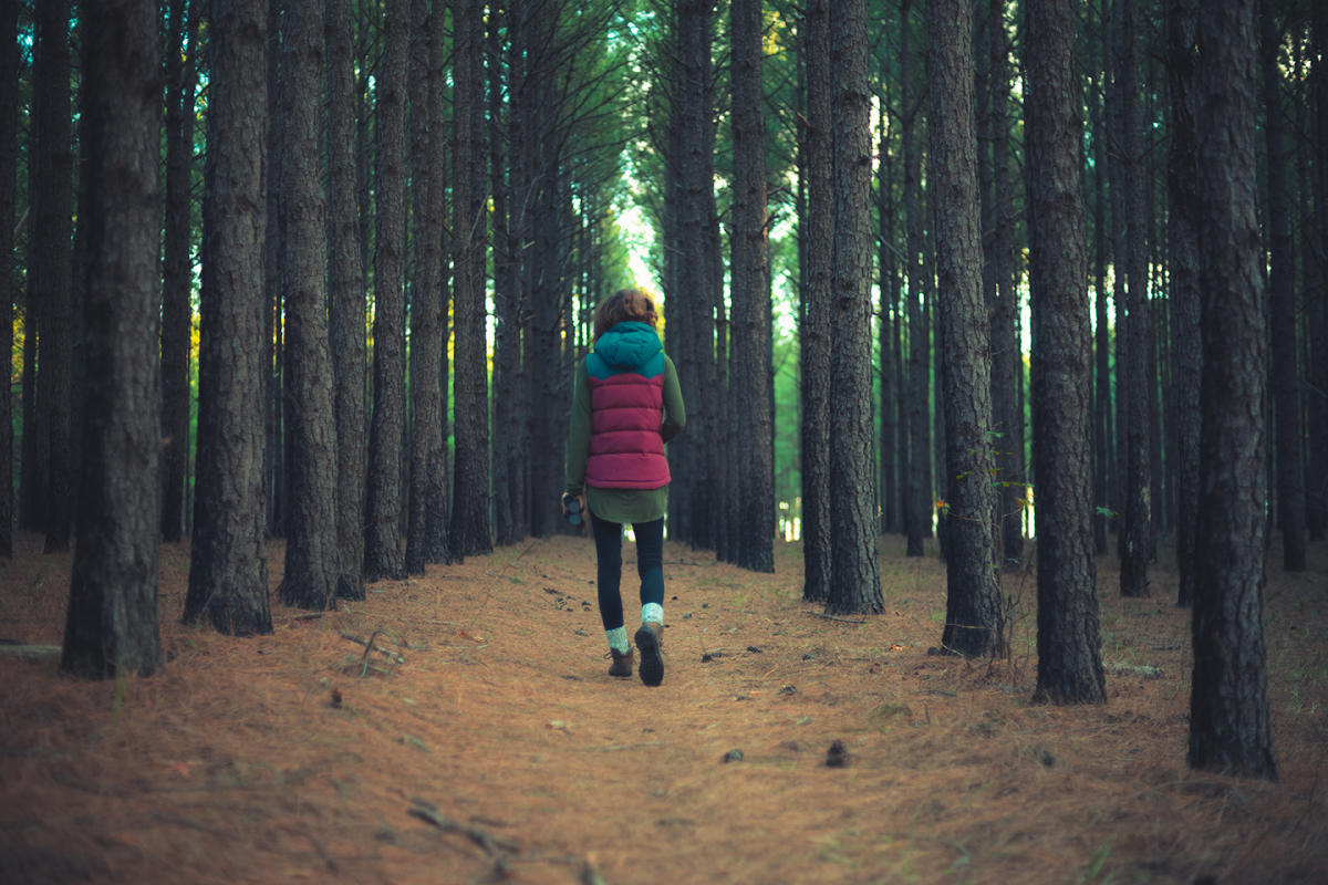 Woman walking through Bartram Forest near Milledgeville