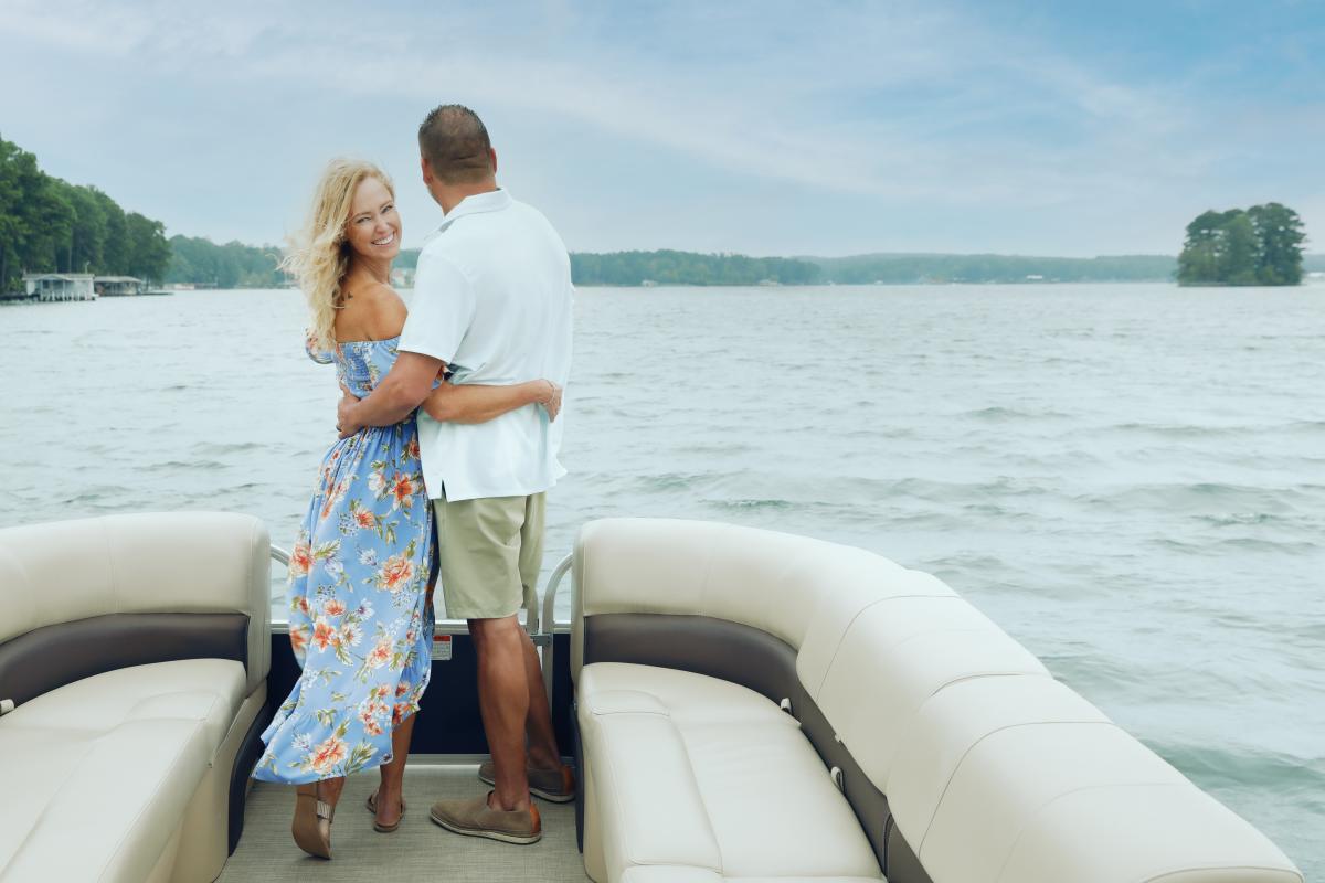 Man and woman embrace on boat cruise of Lake Sinclair.