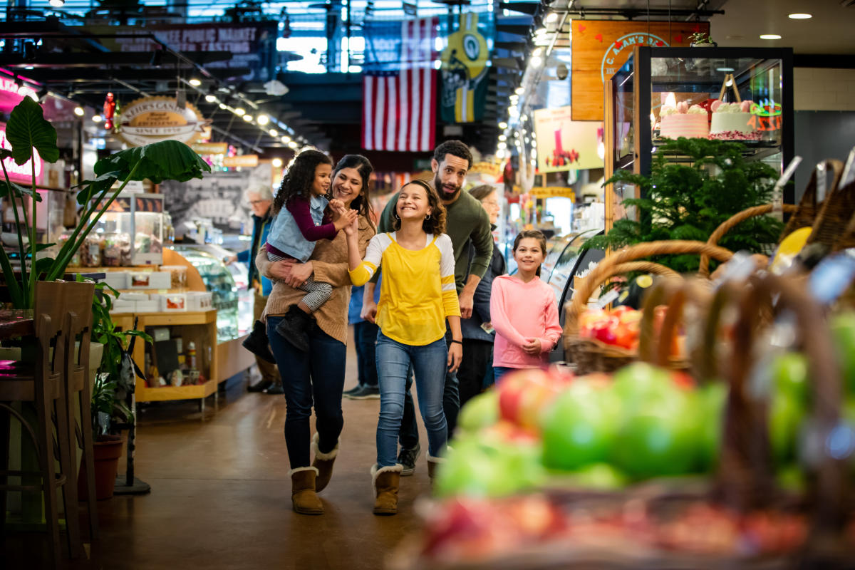 a family walking through the Milwaukee Public Market