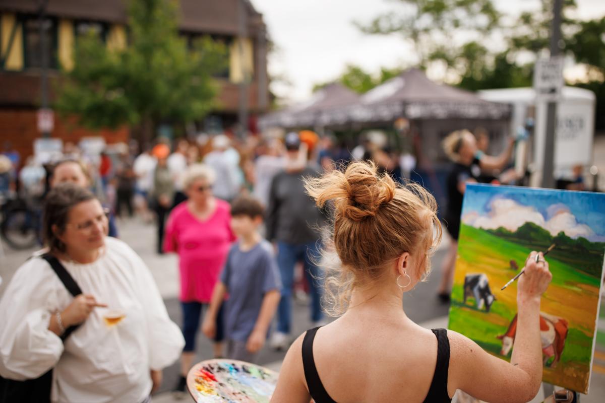 Crowd watching artist paint live at ART 64
