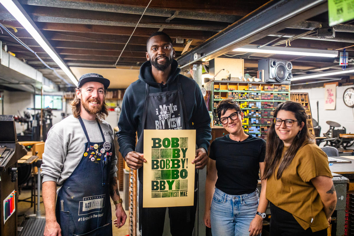 Bobby Portis with the Bay View Printing Co. team, holding his custom printed poster