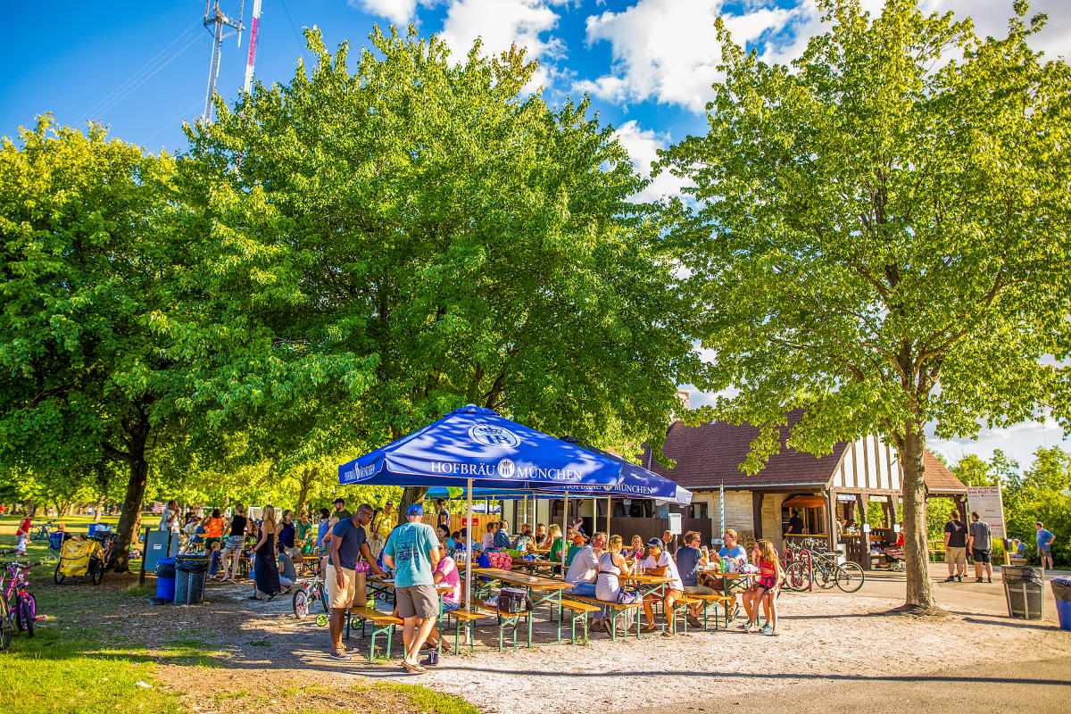 picnic tables filled with people in park