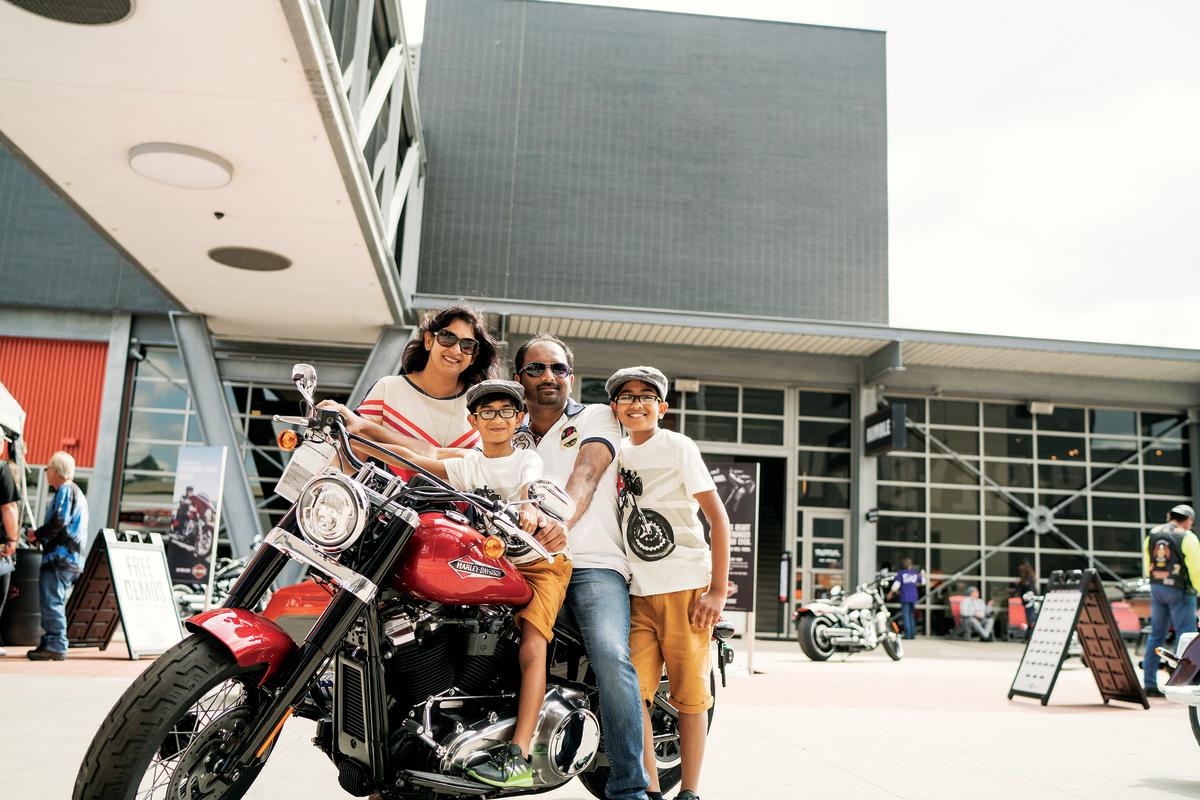 family of four on and around a Harley Davidson Motorcyle