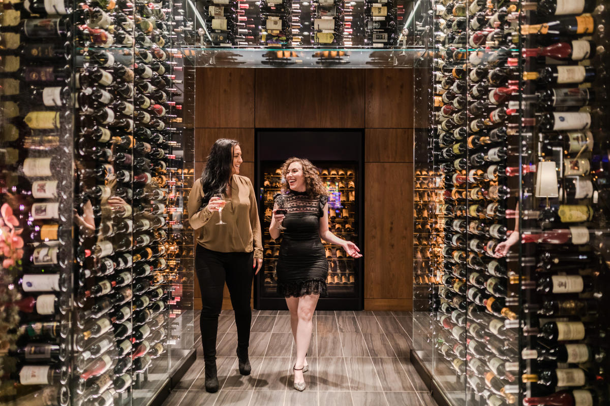 two women with wine walking in "wine tunnel"