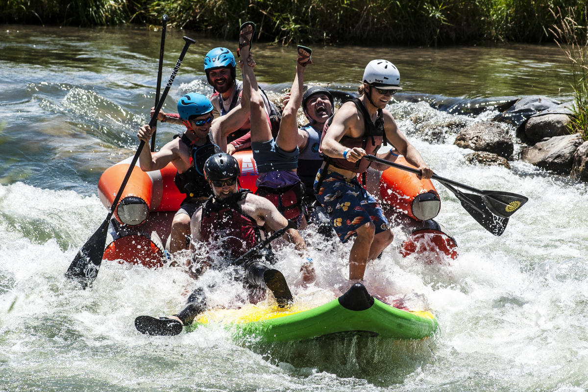 Large paddle-board carrying 6 people goes through a rapid on the Uncompahgre River.