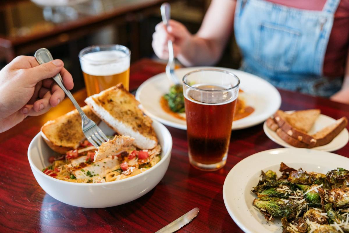 Visitors enjoying craft beer and a meal at Rocky Mount Mills in Rocky Mount, North Carolina
