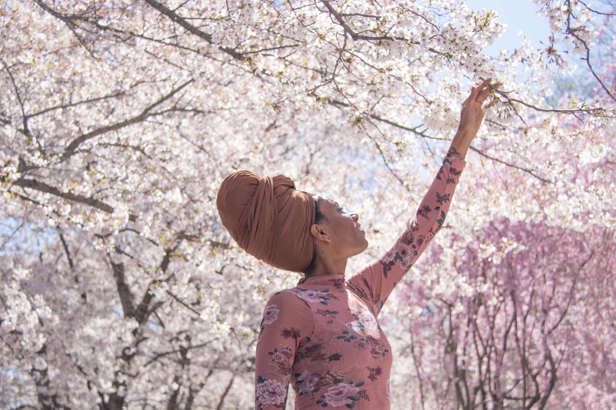 Woman Looking At Cherry Blossoms In Newark, NJ