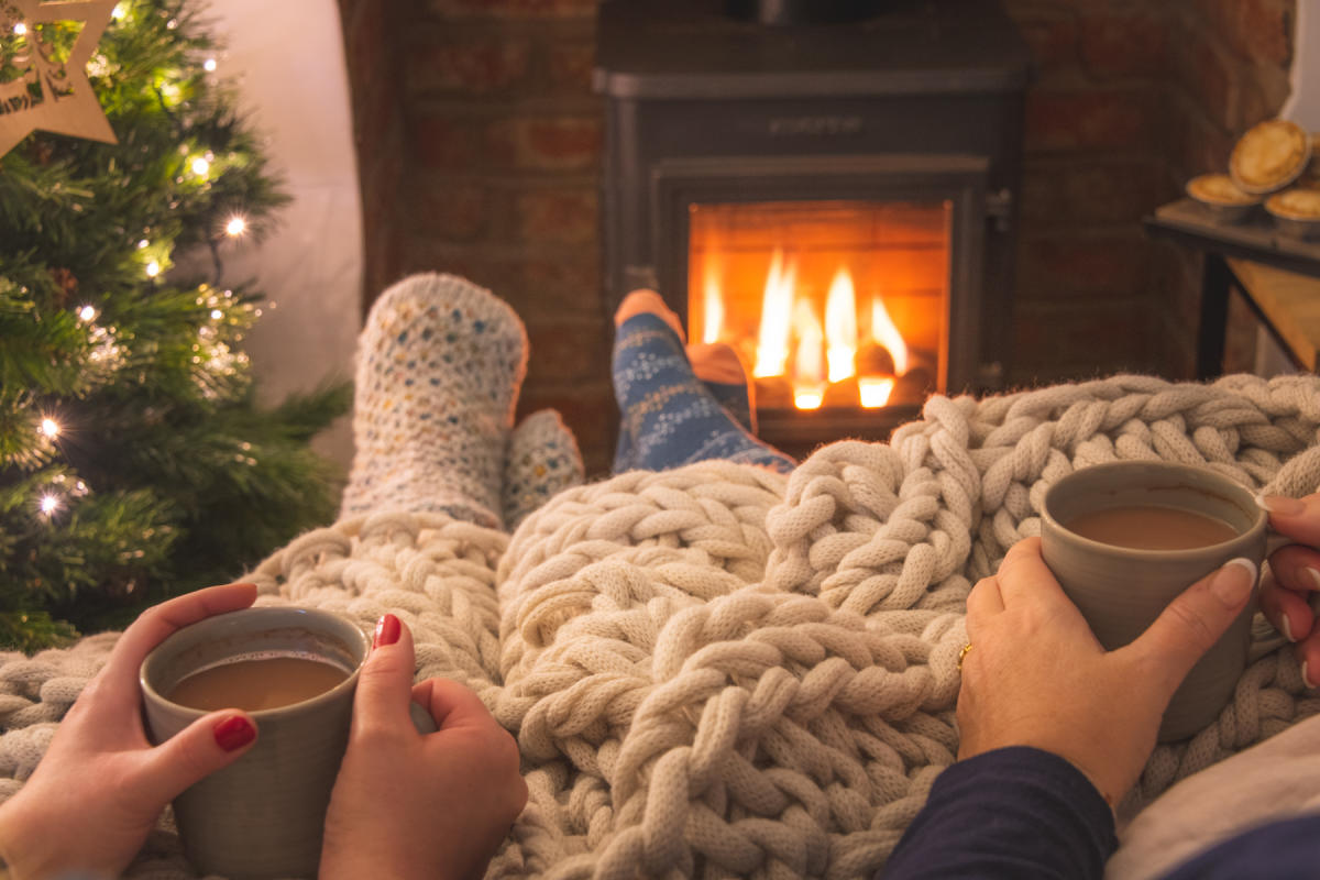 Hot drink by the fire at a New Forest Cottages property