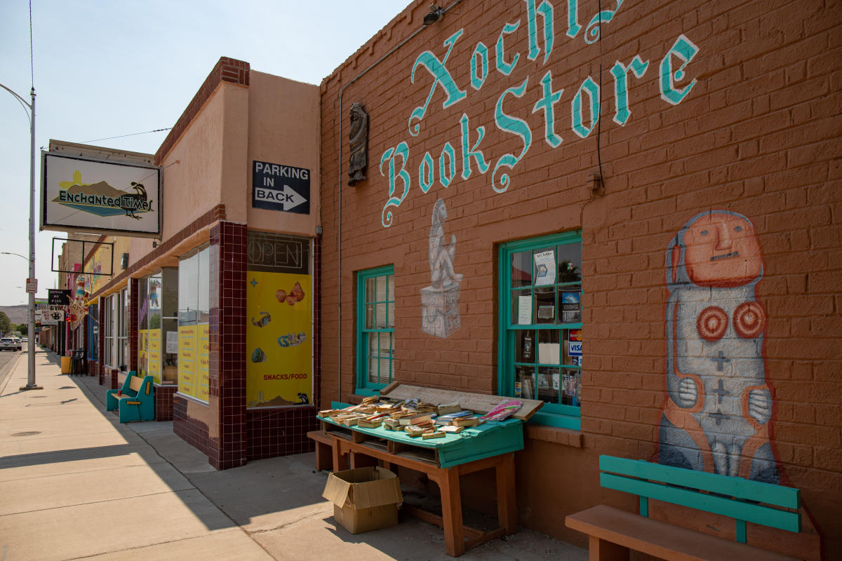 Store fronts line a quiet mainstreet, one of which reads "bookstore"