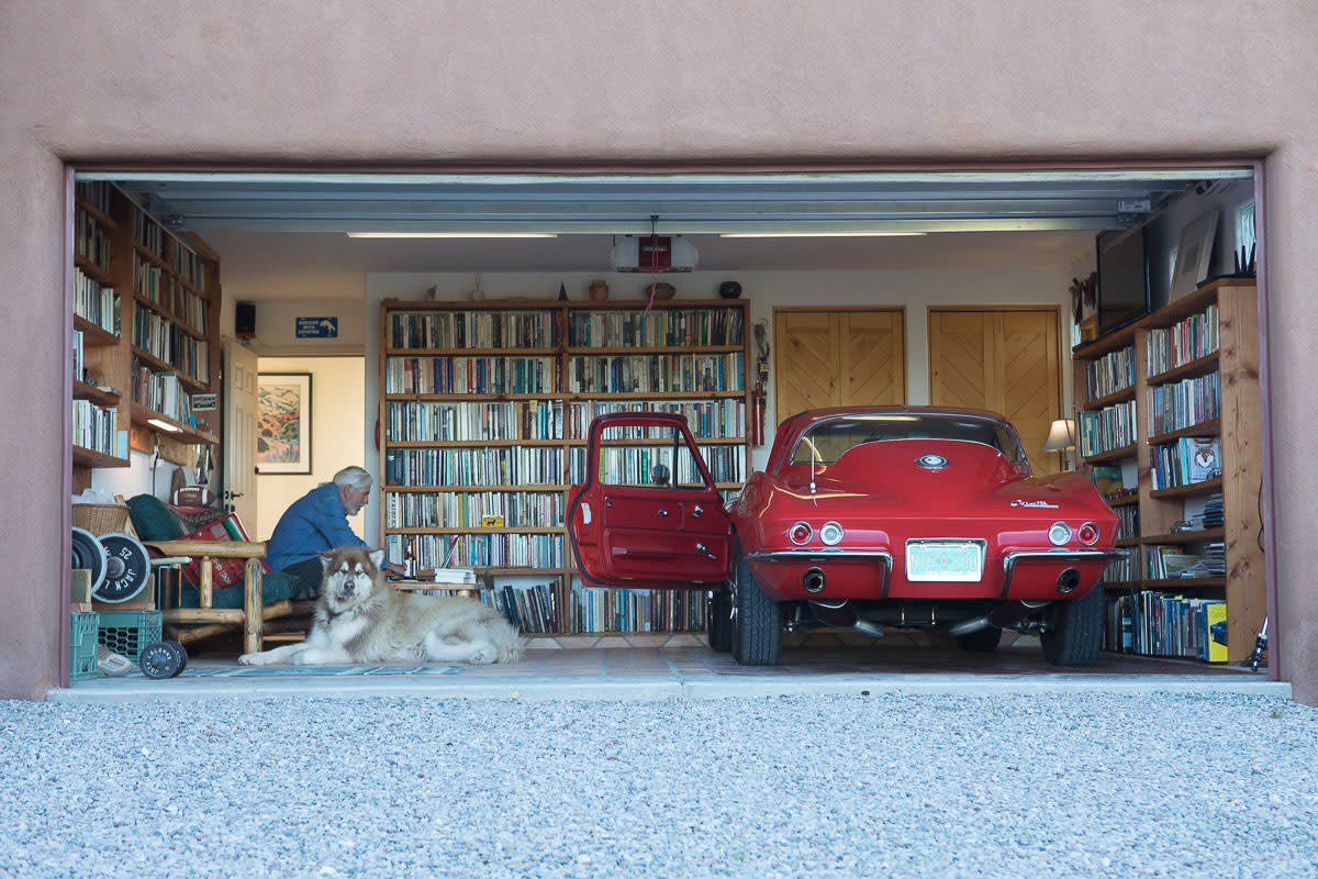 Flores' garage holds two kinds of treasures: book-laden shelves and a little red Corvette.