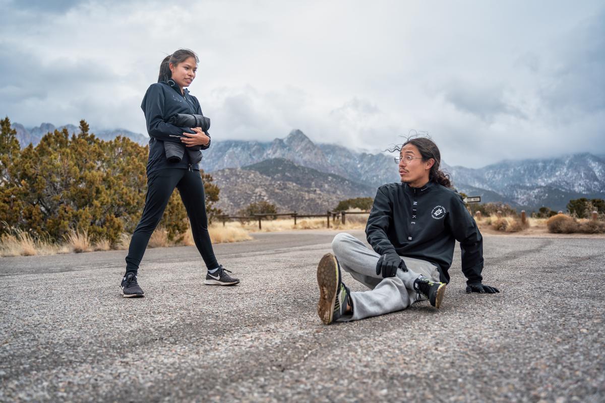 Two people stretching before a run