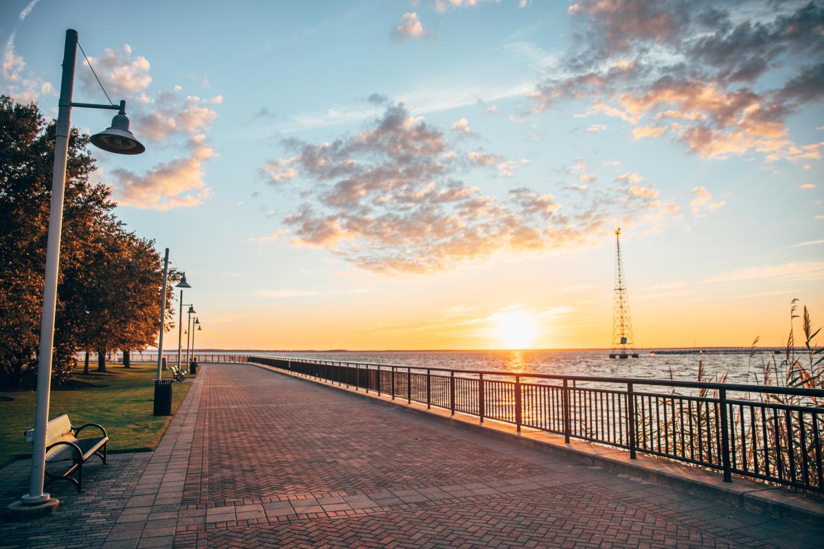 Scenic view of the James River with a bench in the foreground at sunset