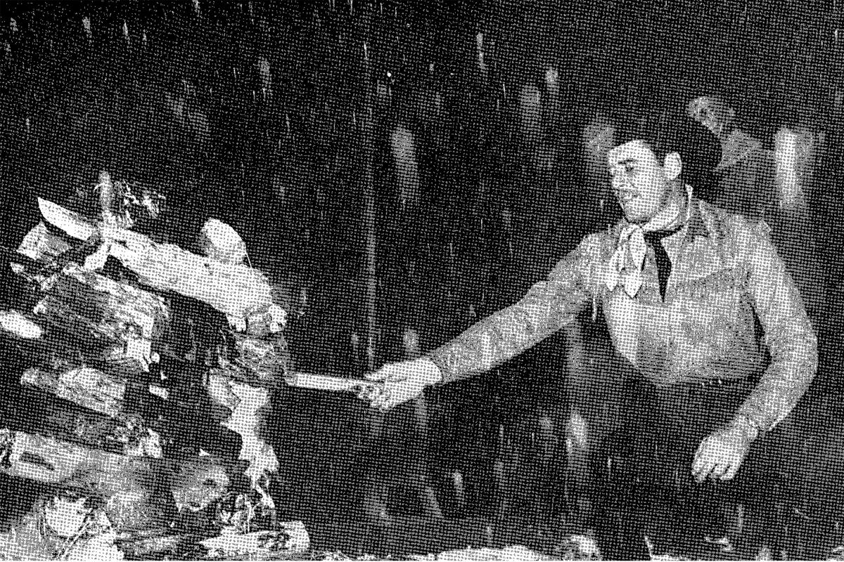 Actor Errol Flynn, in town for a premiere of Santa Fe Trail, lights the bonfire to Zozobra.
