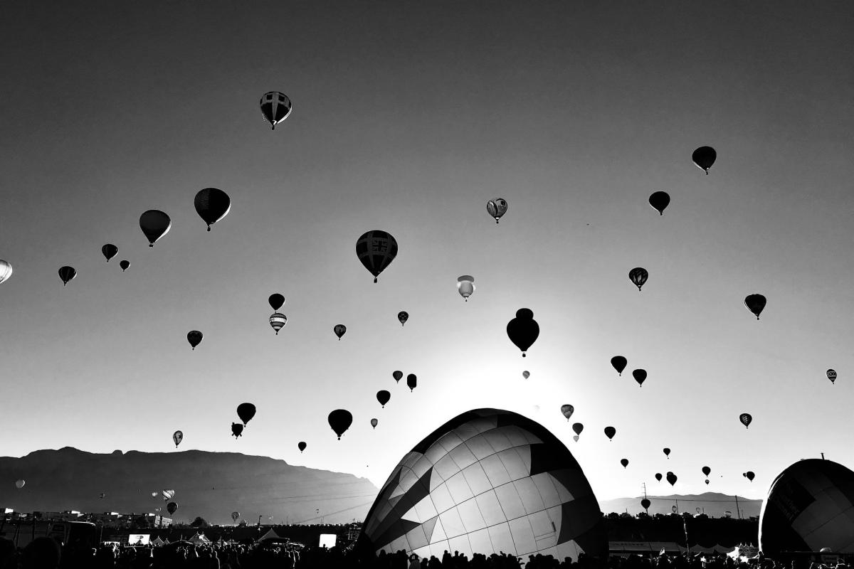 2nd place winner in the Mobile category of the 23rd Annual Photo Contest features a black and white image of hot air balloons taking off into the sky.