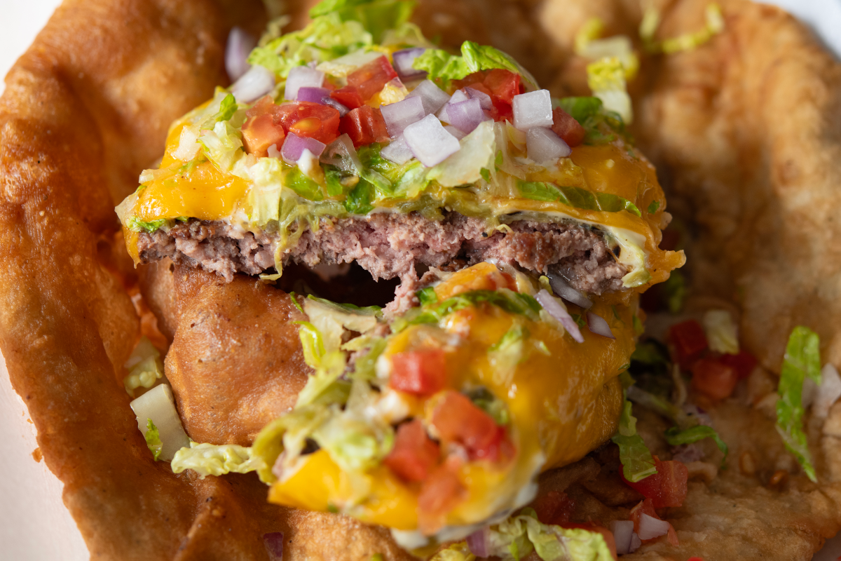 A juicy smashburger served on blue corn frybread.