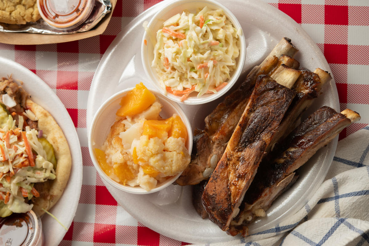 A plate of spare ribs with peach cobbler and coleslaw from Watson's BBQ.
