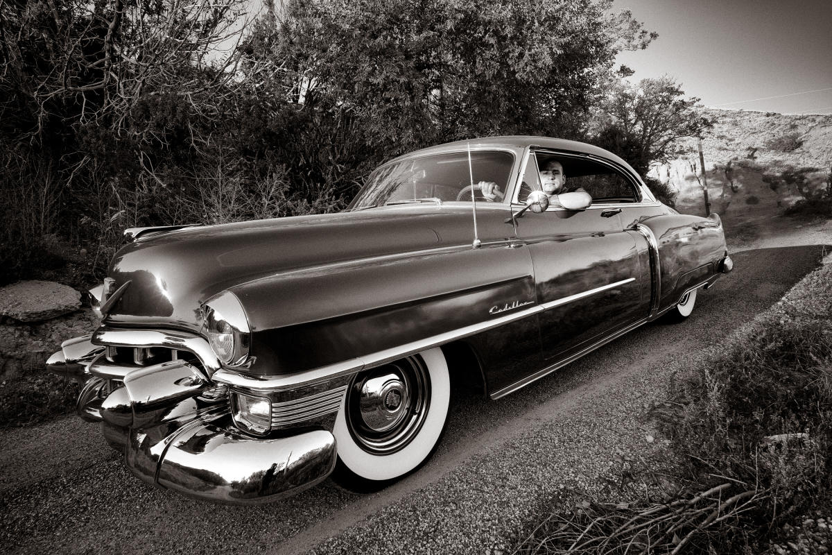 Christopher Martinez hangs out in his 1953 Cadillac in Chimayó, 2015.