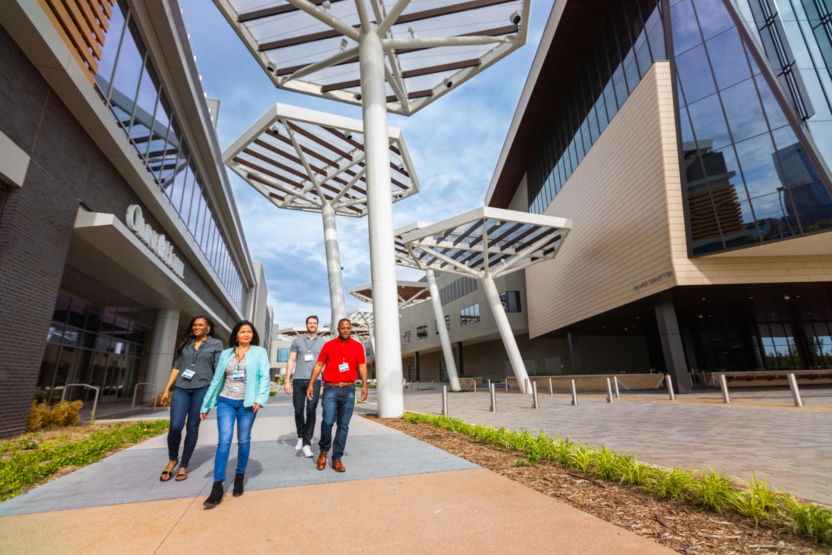 Meeting goers walking down Mick Cornett Drive between the Convention Center and OMNI Hotel