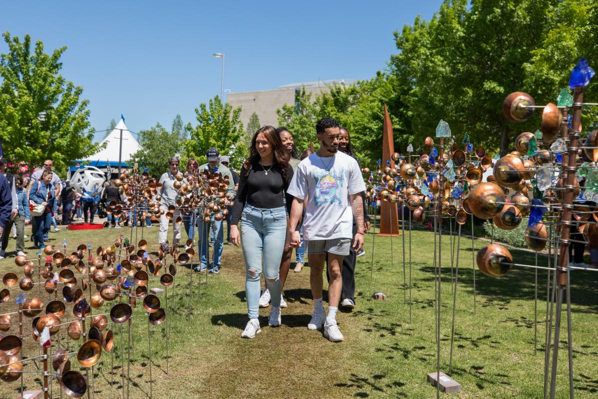 Two couples walking through the Festival of the Arts enjoying the artwork
