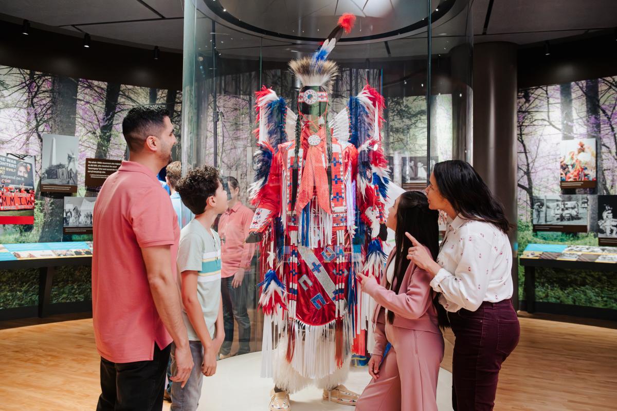 Family looking at Native American regalia at First Americans Museum