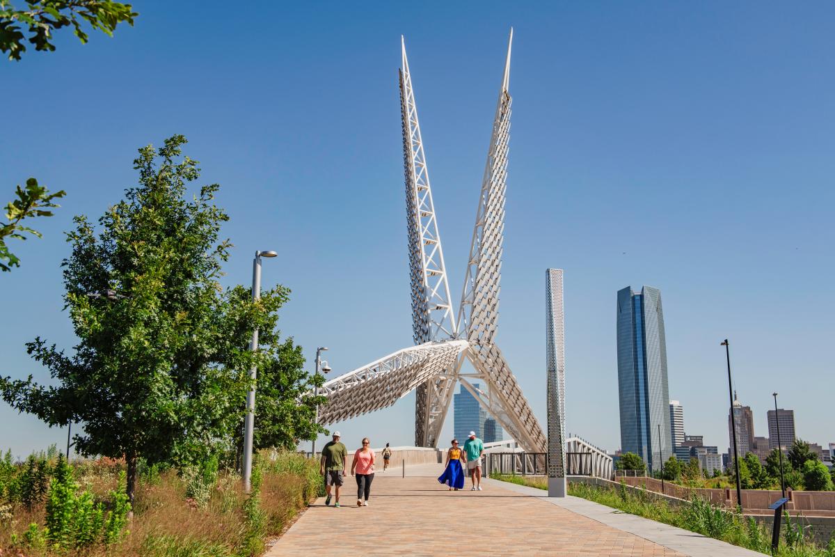People walking over the Skydance Bridge in Scissortail Park
