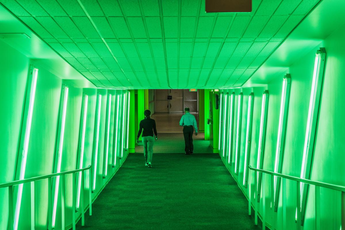 Downtown OKC's Underground tunnels lit up in green with people walking