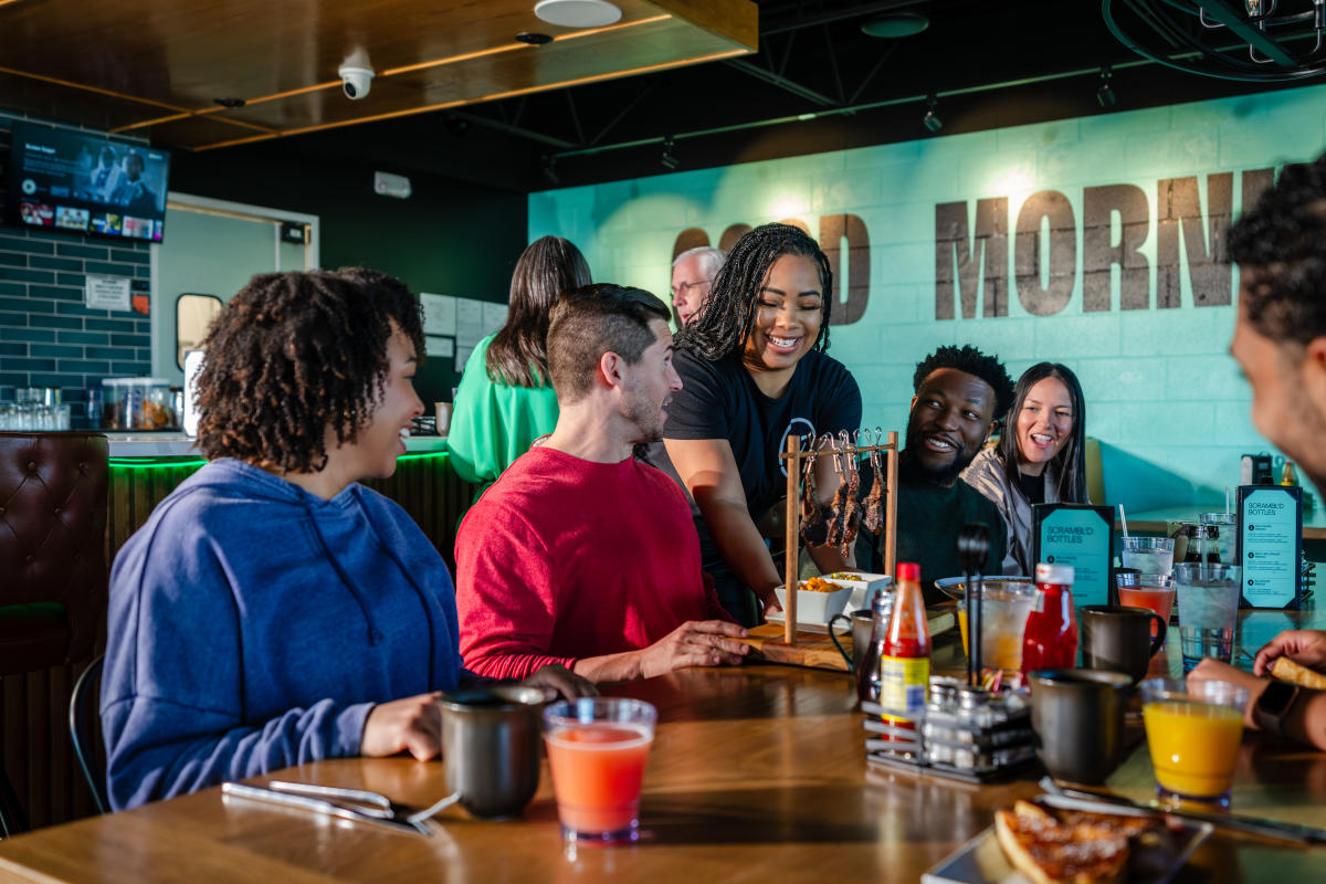 Group of people eating brunch at Scramb'd, located in the East End District