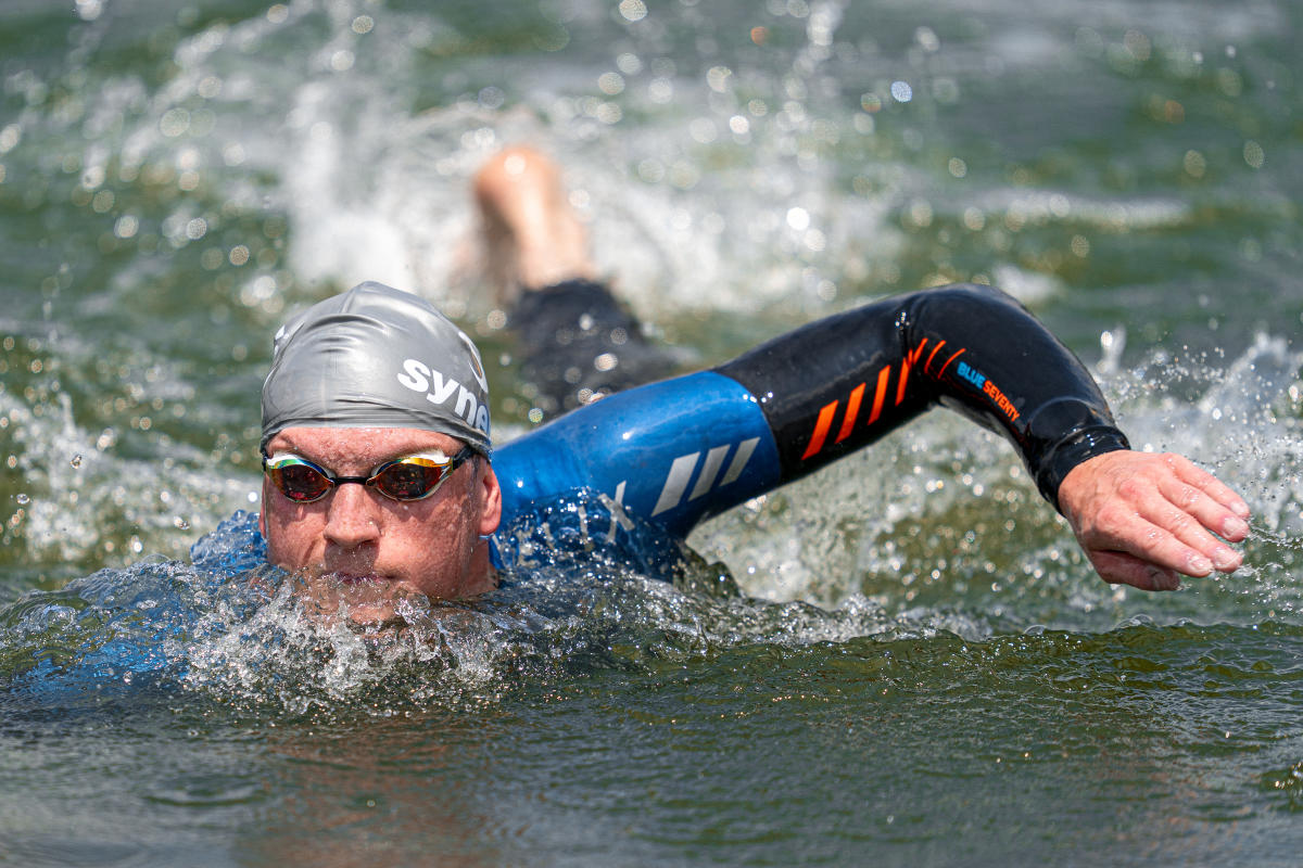 A triathlon athlete swimming at Lake Cunningham.