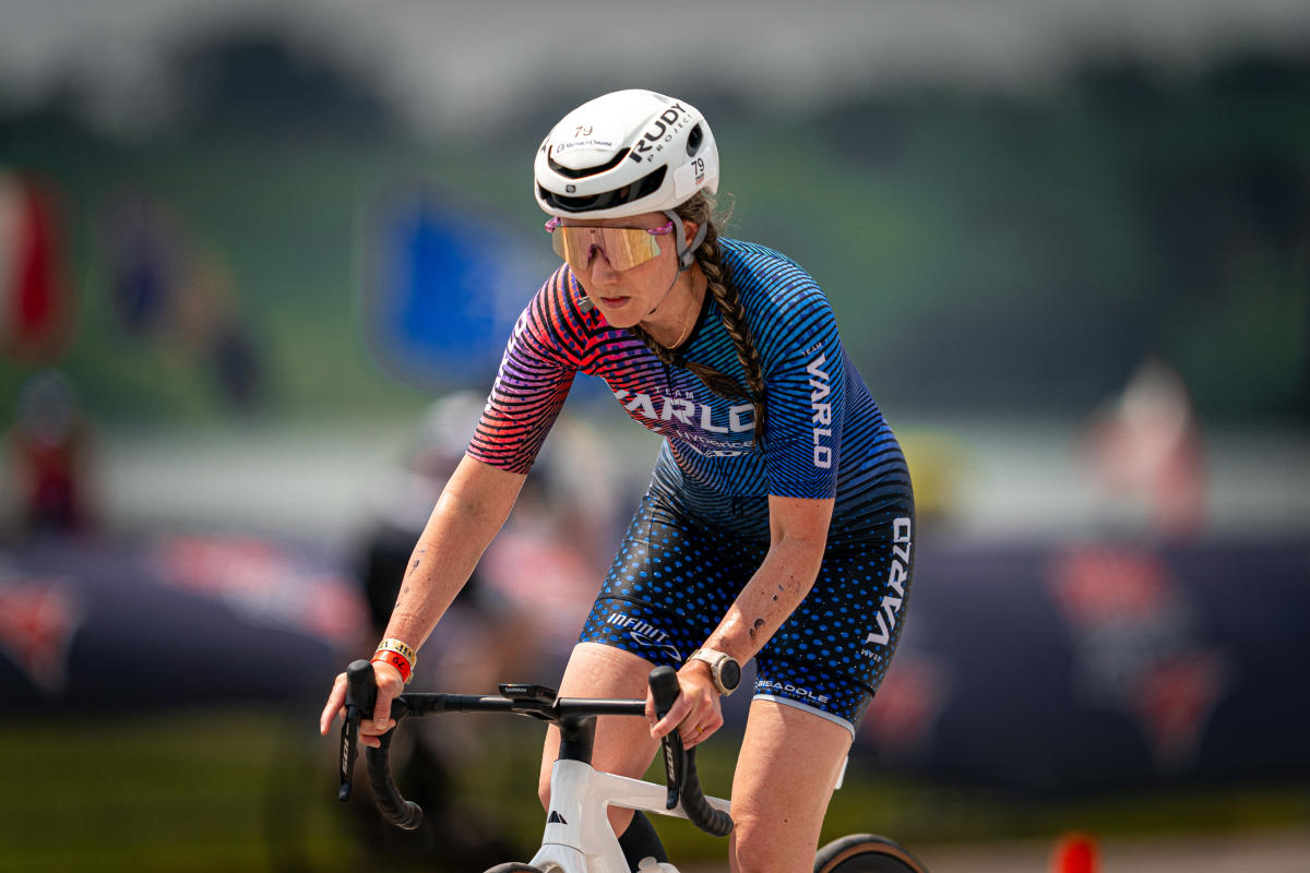 A triathlon athlete riding a bicycle.