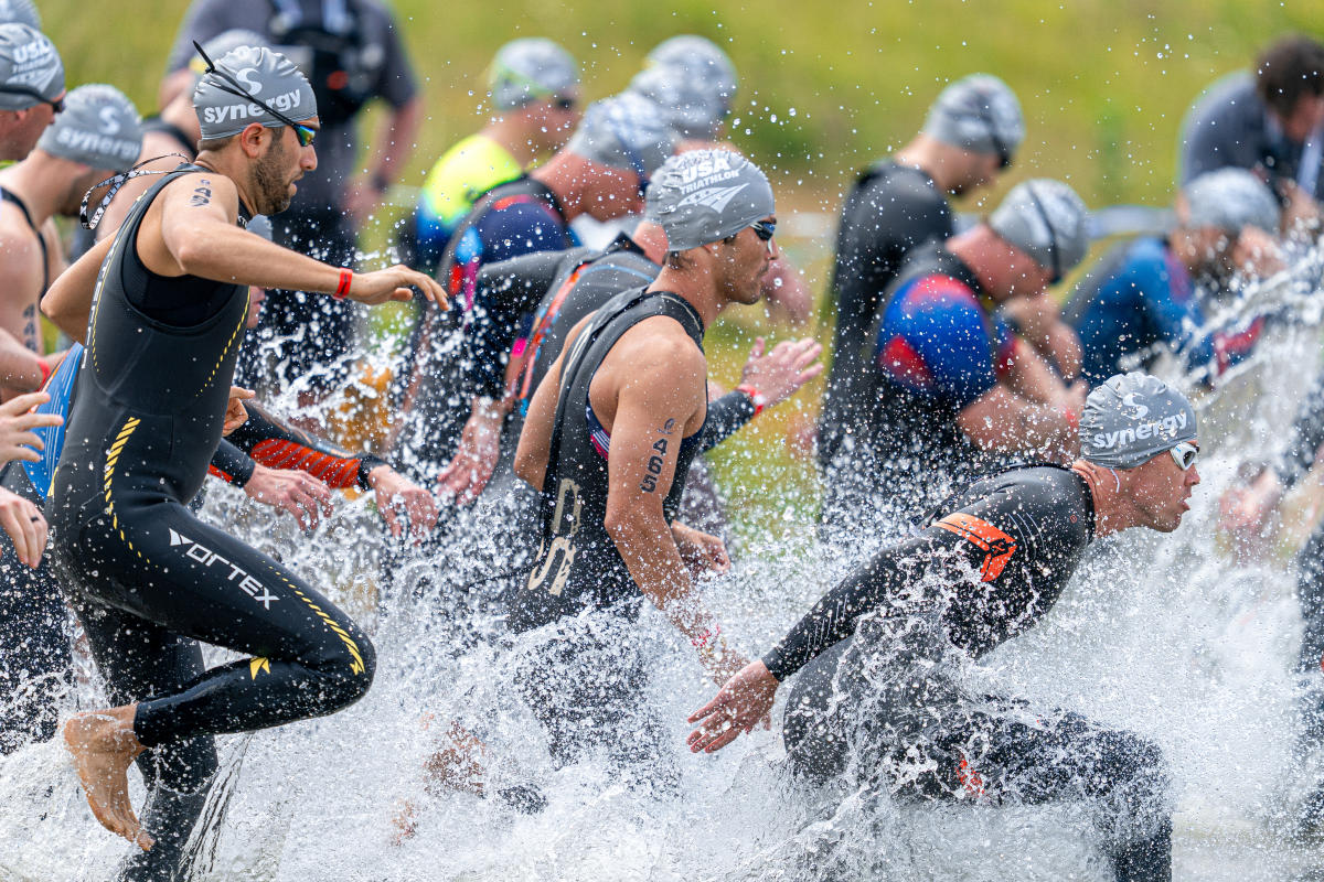 Athletes entering the water for the triathlon event.