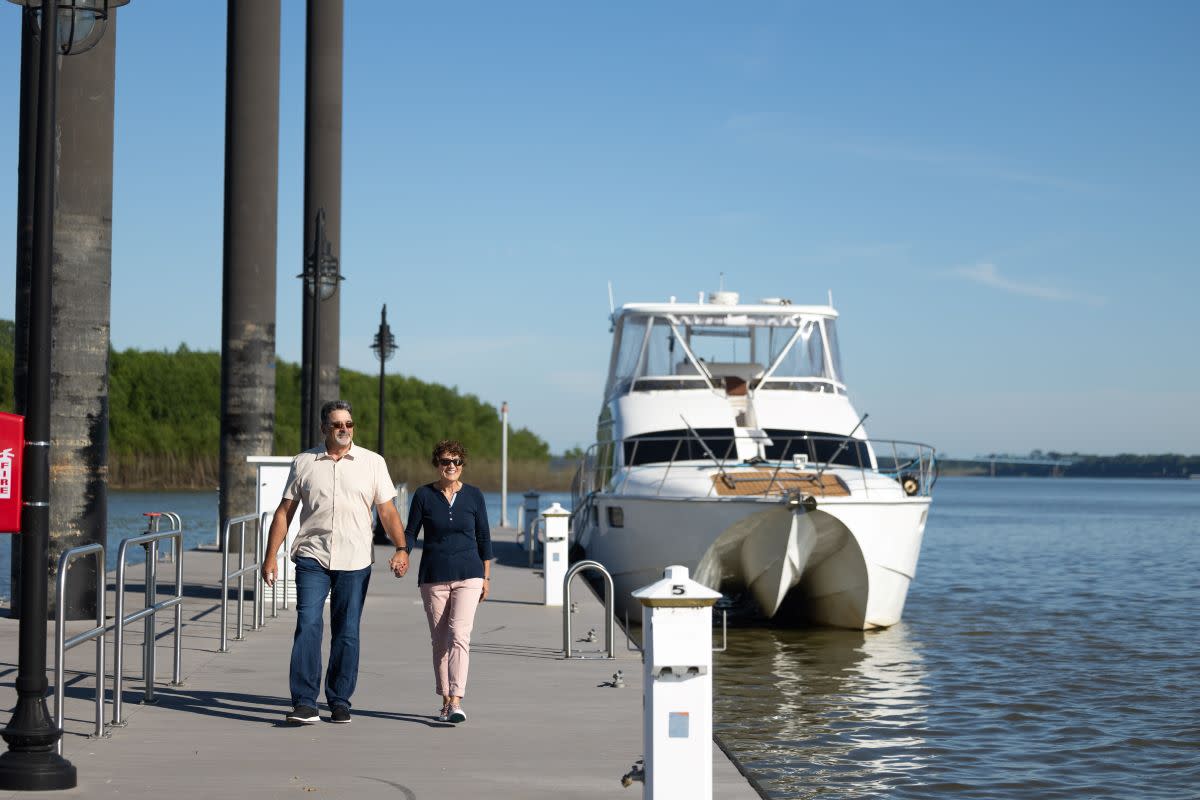 Riverfront Couple By Boat