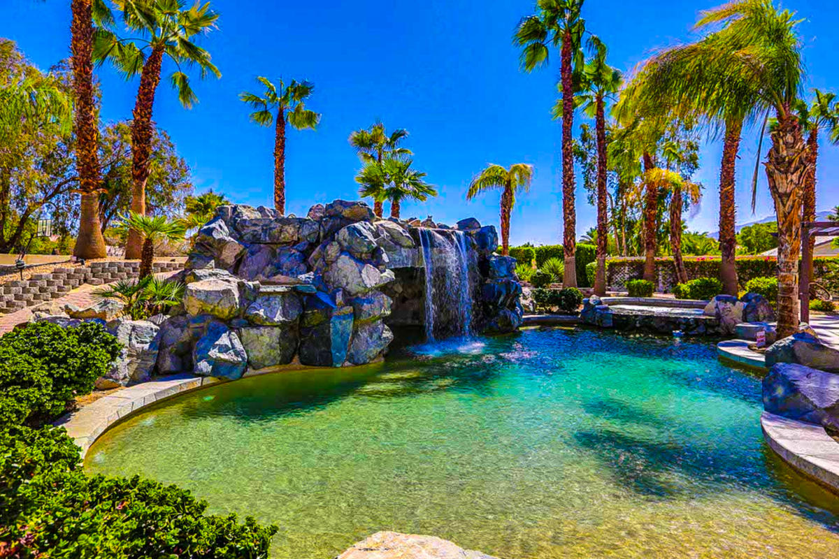 Vacation Rental with Unique Pool and palm trees surrounding the pool