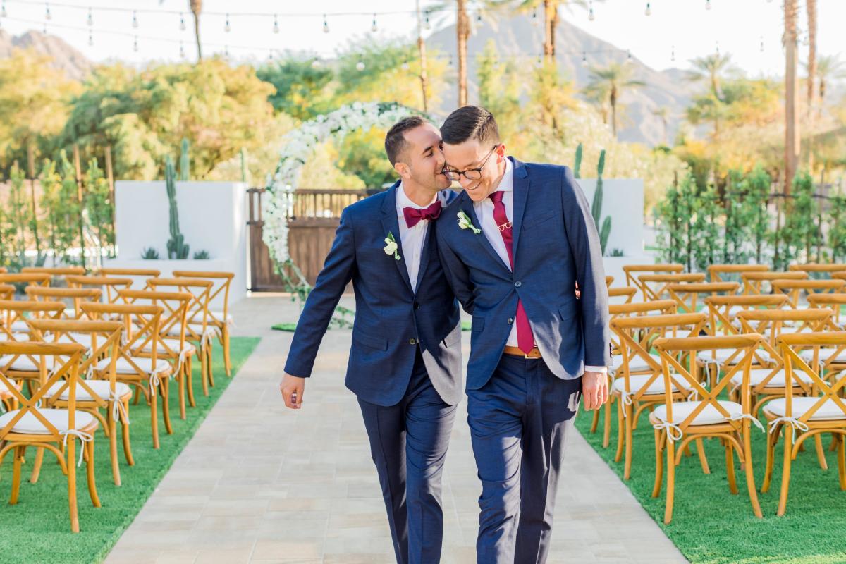 Two men walking down the aisle after getting married
