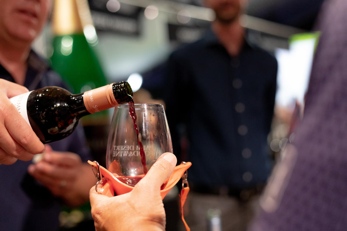 Wine is being poured into a glass during the 2023 Palm Desert Food & Wine Festival.
