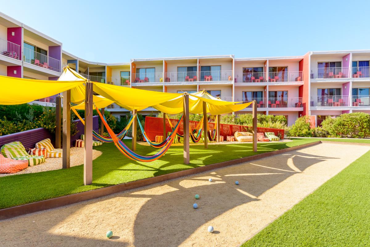 A series of hammocks underneath a shade canopy at Hammock Village at The Saguaro.